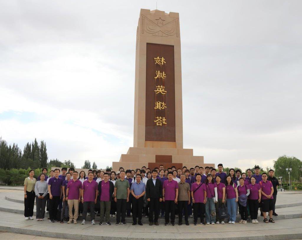 A group of people stand in front of the building and the description is automatically generated